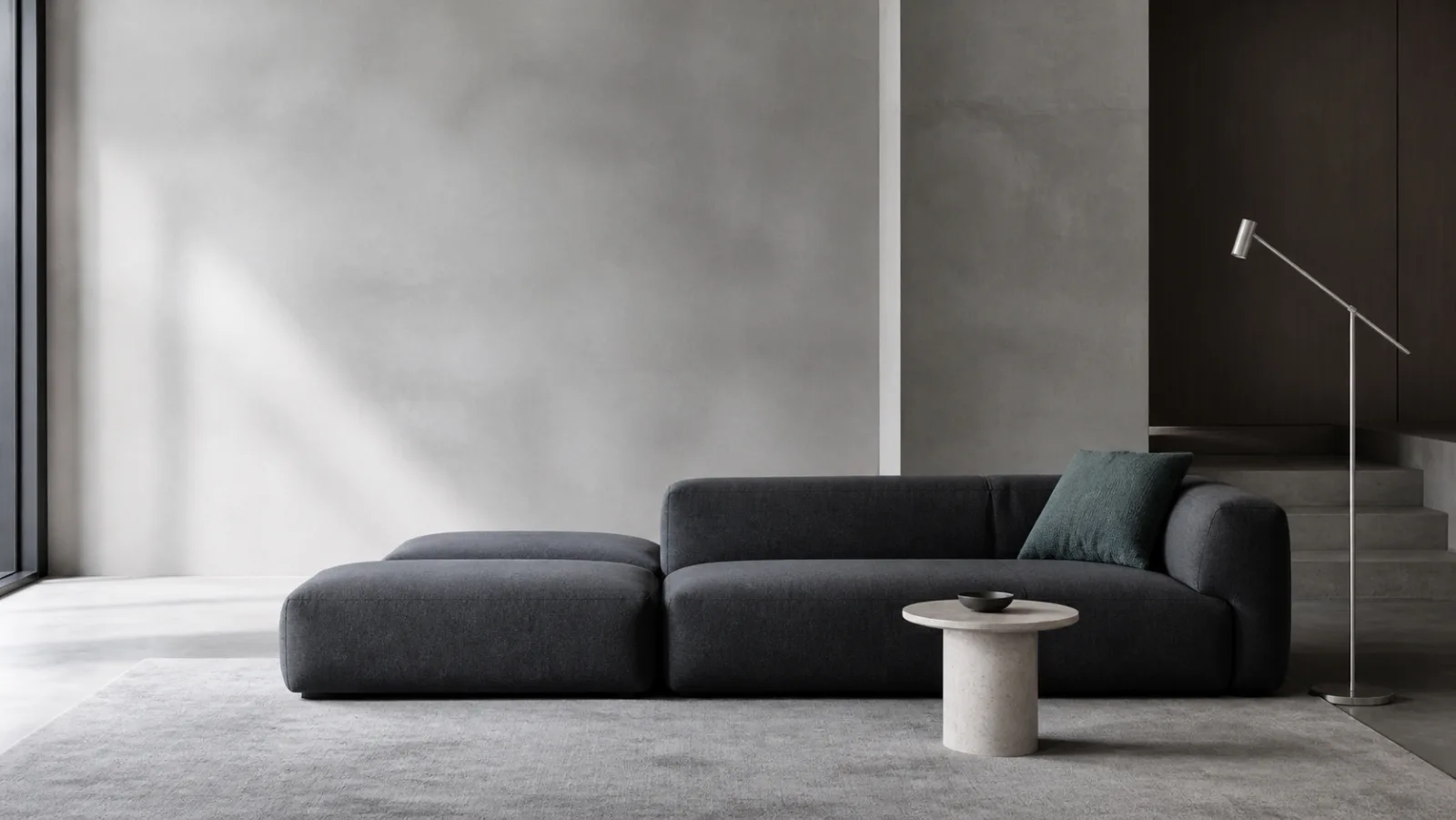 Charcoal modular sofa in a light architectural interior