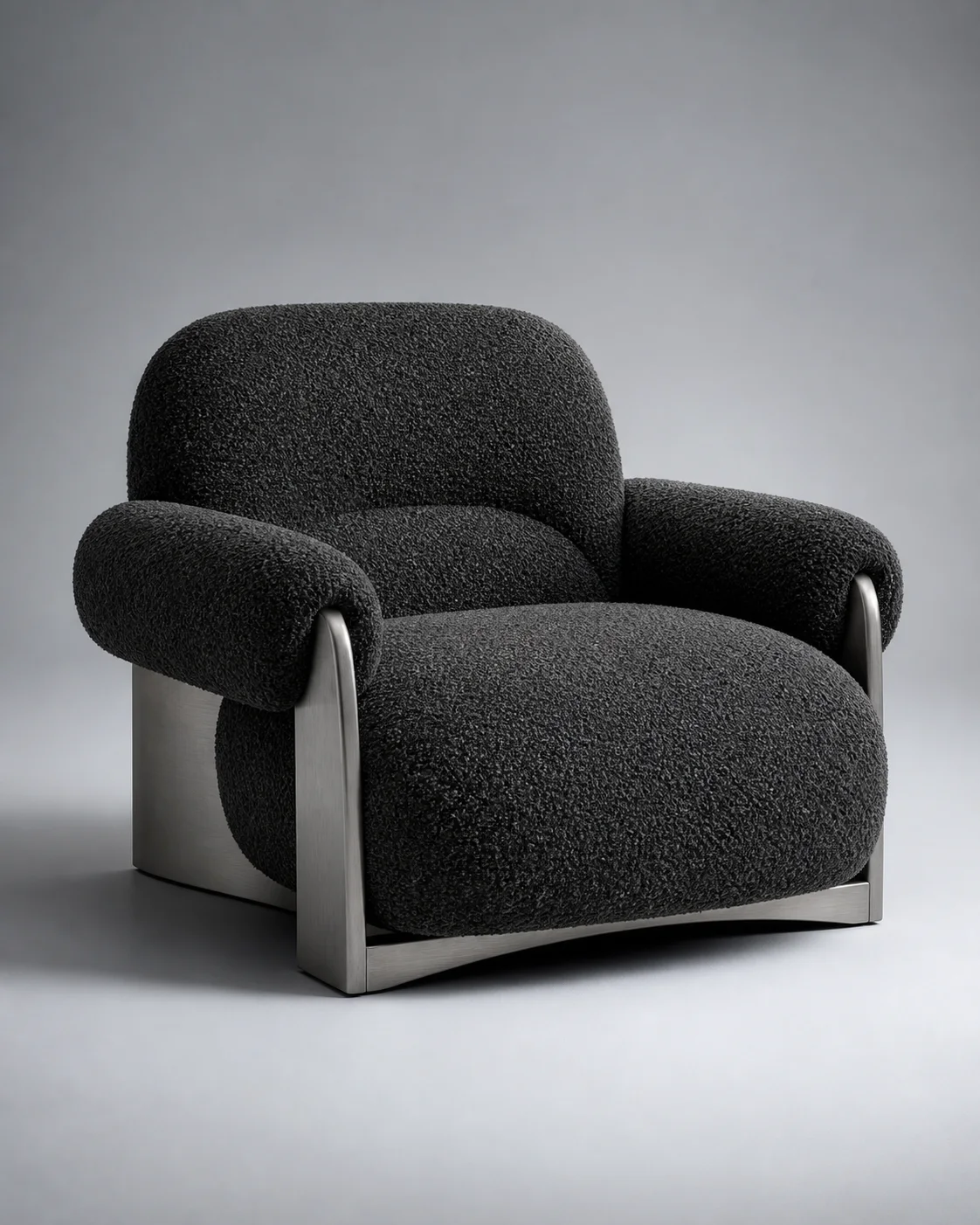 Charcoal bouclé lounge chair with brushed metal supports